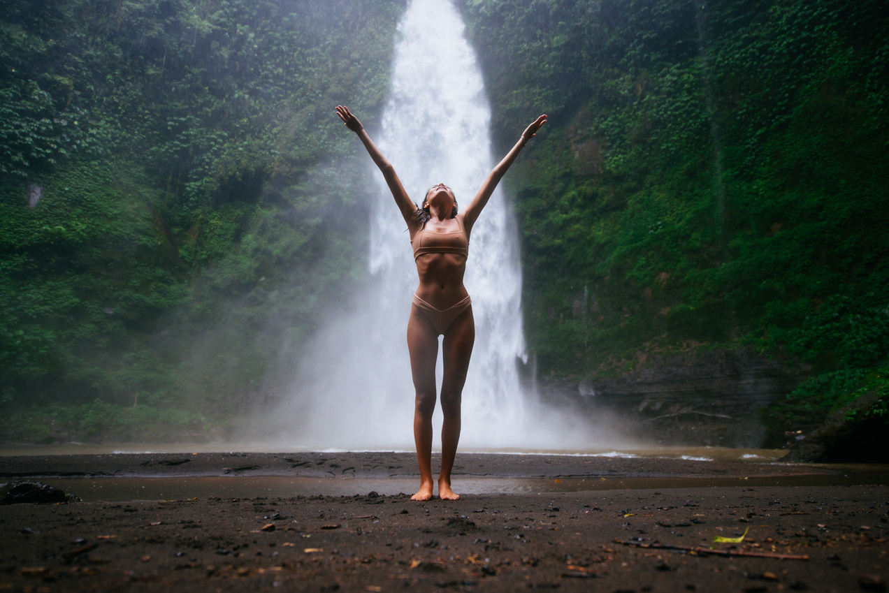 Beautiful Girl Enjoying Nature and Waterfalls in Bali